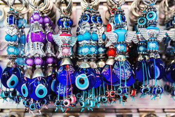 Colorful Turkish evil eye amulets and beaded keychains for sale as traditional souvenirs in Izmir,...