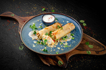 Savory pancakes stuffed with mushrooms and potatoes on a dark background. Rustic and hearty dish.