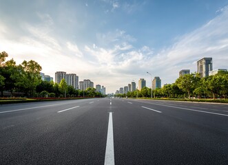 High-speed highway, an asphalt road with trees and buildings in the background. The wide-open plain is empty of cars on an early summer day. In the front view, white lines mark the right side for driv