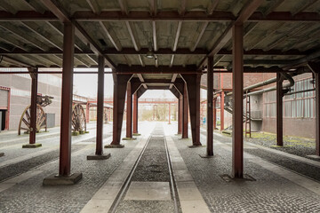 Railway tracks with a roof on top at a old coal mine in Zollverein Coal Mine Industrial Complex,...