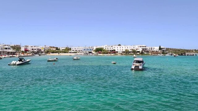 Video showing yachts and sailboats peacefully docked at the scenic marina on Antiparos Island, Greece.