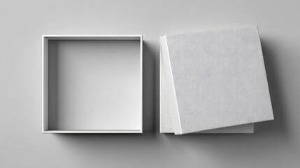 Elegant square empty box with lid on plain grey surface for gift packaging display.