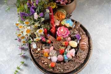 Altar for Summer solstice, Litha wiccan holiday. wheel of the year with flowers, crystals, amulets and candle on table. magic ritual. symbol of celtic summer sabbat. Midsummer. top view