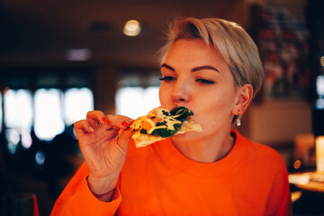 woman eating pizza