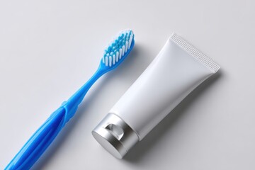 Toothbrush and toothpaste tube laid out on clean white