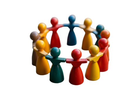 A Group of Multicolored Wooden Figurines Forming a Tight Circle on a Textured Stone Surface