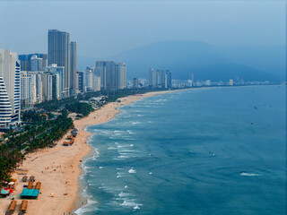 Aerial view of Da nang beachfront and cityscape with mountains in the background