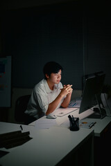 Serious entrepreneur concentrating on tasks during overtime