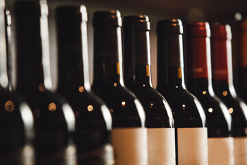 Close-Up View of Wine Bottles Lined Up on Wooden Shelf, Highlighting Variety and Elegance