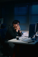 Overworked young businessman stressed by long working hours
