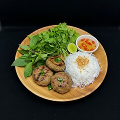 Vietnamese bún chả with grilled pork patties and rice vermicelli, drizzled with nuoc cham, arranged with fresh herbs like cilantro and perilla on A Teak Wood Platter,
