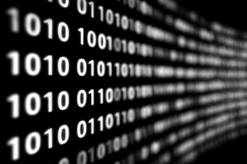 Close up of digital binary code on black background representing technology and data transfer.