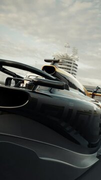 Dynamic low angle front view shot of a generic formula one race car racing along the homestretch over the finish line. 3D animation rendering. New 2025 black and gold race car design