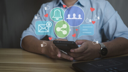 Man using smartphone with social media icons overlay. Concept of digital marketing, online communication, notification, and social network engagement.