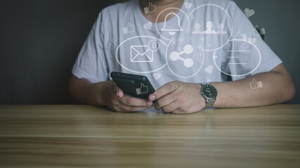 Man using smartphone with social media icons overlay. Concept of digital marketing, online communication, notification, and social network engagement.