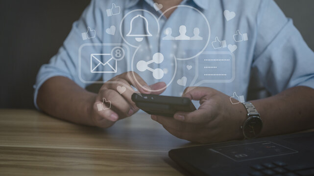 Man using smartphone with social media icons overlay. Concept of digital marketing, online communication, notification, and social network engagement.