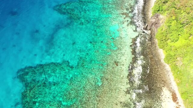 Clean shallow beach waters coral reefs around Tokoriki island in Fiji &ndash; aerial top down.
