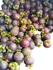 Mangosteen is Thailand’s national fruit, known as the Queen of Fruits. It has a sweet and slightly sour taste. Fresh tropical fruit on white background.