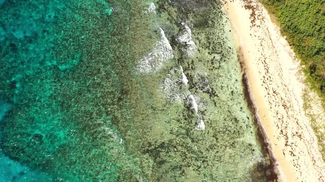 Clear Pacific ocean waters at corals reefs of Tokoriki island Hideaway beach &ndash; top down aerial view.
