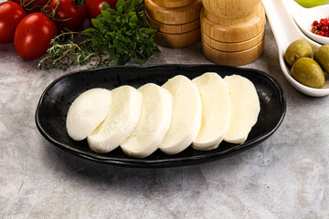 Organic mozzarella cheese slices in the plate