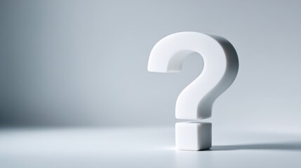 Minimalist white question mark sculpture on smooth surface with soft shadows and neutral background.