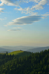 Small shepherd's hut on the top of the Bucegi hill in the early morning light
