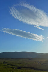 Strange cloud formation on a cold breezy morning at the beginning of summer in Bucegi