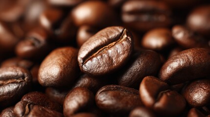 Close-up of roasted coffee beans with rich brown color and detailed texture.