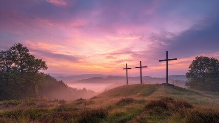 Obraz premium Beautiful sunrise over rolling hills with three crosses and misty landscape scene.