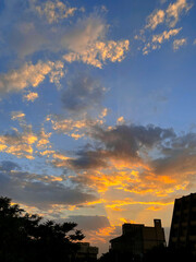 “Dramatic sunset over city buildings with glowing clouds”
