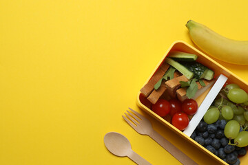 healthy lunch box with school backpack, apple and stationery on color background