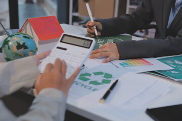 Asian woman lead young group of multiethnic businesspeople in team meeting, using laptop computer for ESG topic presentation on monitor. Sustainable business practice, people work at home concept