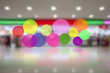 Abstract colorful circles float over a blurred mall interior
