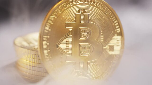 Golden Bitcoin coin with smoke drifting around it, symbolizing cryptocurrency and digital finance