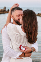 Young happy couple kissing on the sea beach in summer