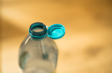 Plastic cap connected to a plastic bottle. Bottle design with the cap attached to the bottle for...