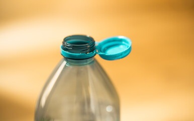 Plastic cap connected to a plastic bottle. Bottle design with the cap attached to the bottle for...