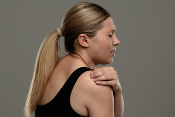 Woman Experiencing Acute Shoulder Discomfort and Pain Expression