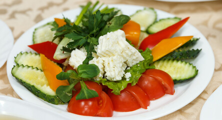 Plate with cut vegetables and cheese