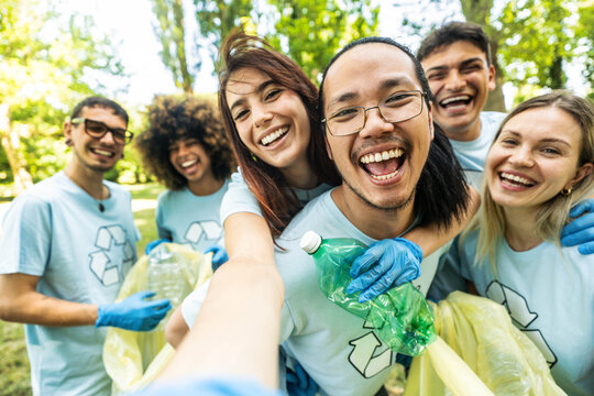 Group of volunteer cleaning picking up plastic litter in the park - Diverse group of people collect trash in the forest - Environmental protection, non profits organization and save the planet concept