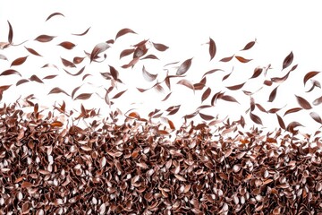 Brown leaf-like fragments cascade over a dense pile