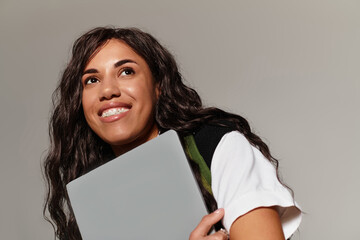 Capturing the youthful charm of a student with beautiful aesthetics holding a laptop