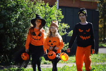 Happy family walk in the park on Halloween. Family dressed up in Halloween costumes