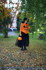 Happy family walk in the park on Halloween. Family dressed up in Halloween costumes