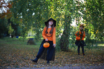 Happy family walk in the park on Halloween. Family dressed up in Halloween costumes