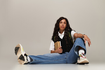 Young student exuding confidence and style in a modern study space during afternoon