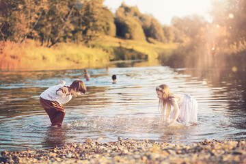 Children walk in the park in autumn. Child outdoors on a sunny summer morning in the park.