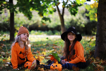 Happy family walk in the park on Halloween. Family dressed up in Halloween costumes