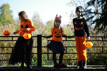 Happy family walk in the park on Halloween. Family dressed up in Halloween costumes