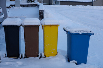 Garbage bins of different colors near the house. Recycling, sorting garbage in the city